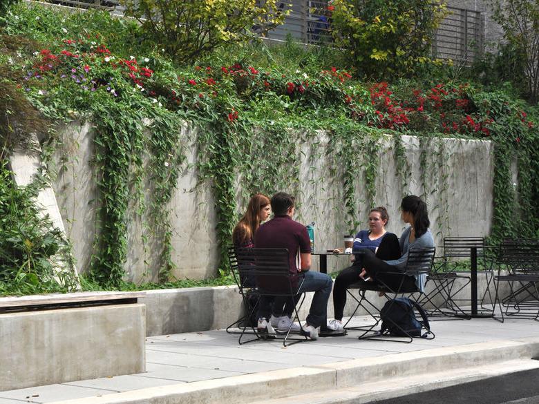 4 students sitting outside of Penn State Abington Woodland Building near Philadelphia